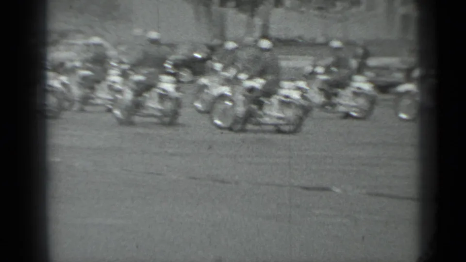 A group of motorcycle police with sidecars forms on the roadway during the supplied 1983 Moscow escort scene.