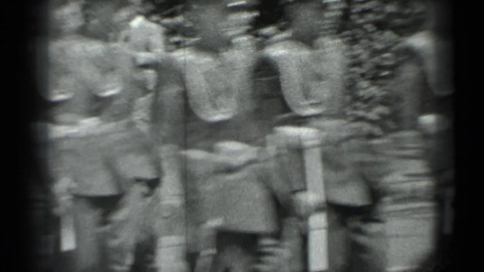 Uniformed soldiers in peaked caps appear to march in formation beside hedges in the Moscow footage.