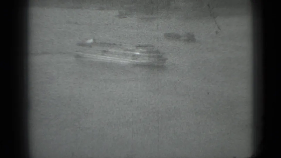 Distant multi-deck ferry on a wide Moscow river, filmed in soft black-and-white 8mm in 1983.