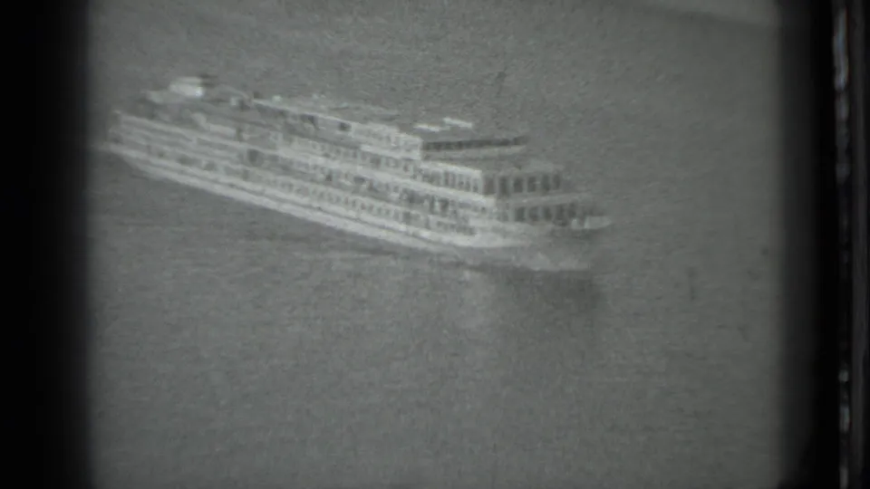 The 1983 Moscow 8mm footage shows the ferry broadside on the river, framed by grain and dark film edges.