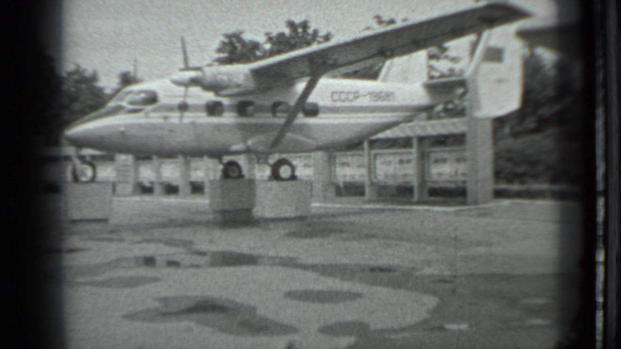 Aircraft marked CCCP-19581 displayed on blocks beside a small shelter.