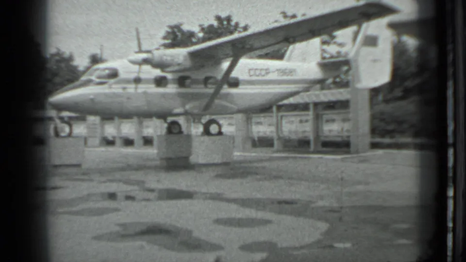 Soviet-era aircraft marked CCCP-19581 rests on display supports in Moscow, with a shelter and trees in the background.