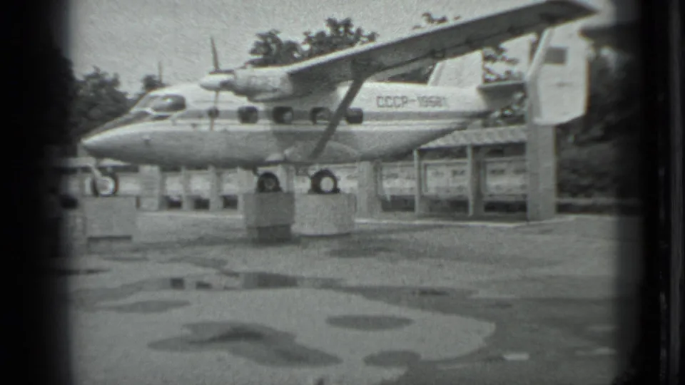 Final 1983 Moscow frame shows the CCCP-marked aircraft on outdoor supports, with puddled pavement and trees beyond.