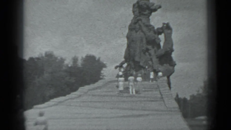 1983 8mm view of visitors gathered below a large Moscow statue, seen through grainy black-and-white home-movie footage.
