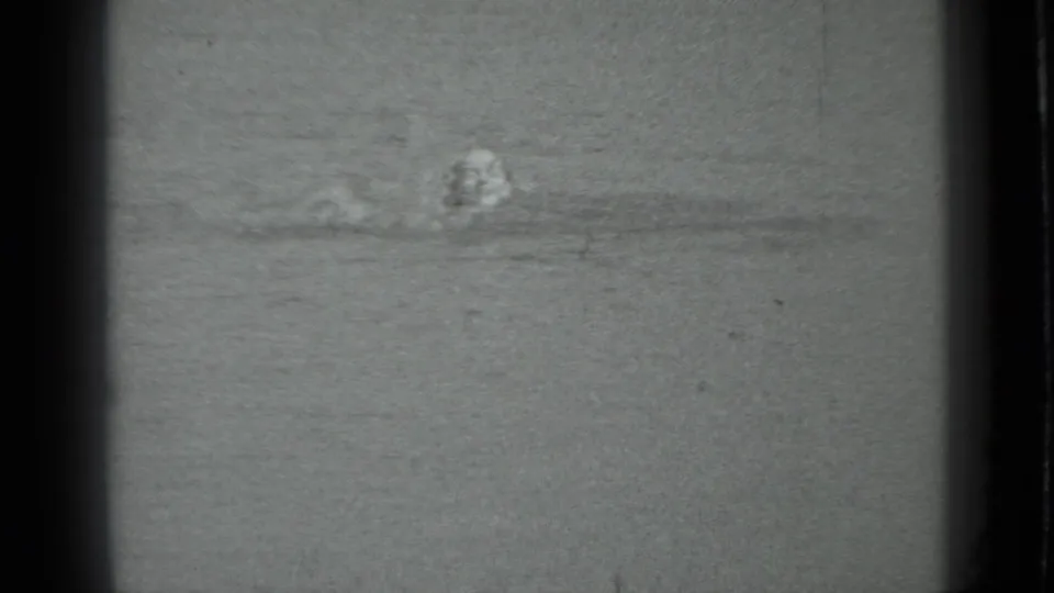 The swimmer faces the camera while moving through lake water in the supplied Moscow, Russia, 1983 8mm home-movie frame.