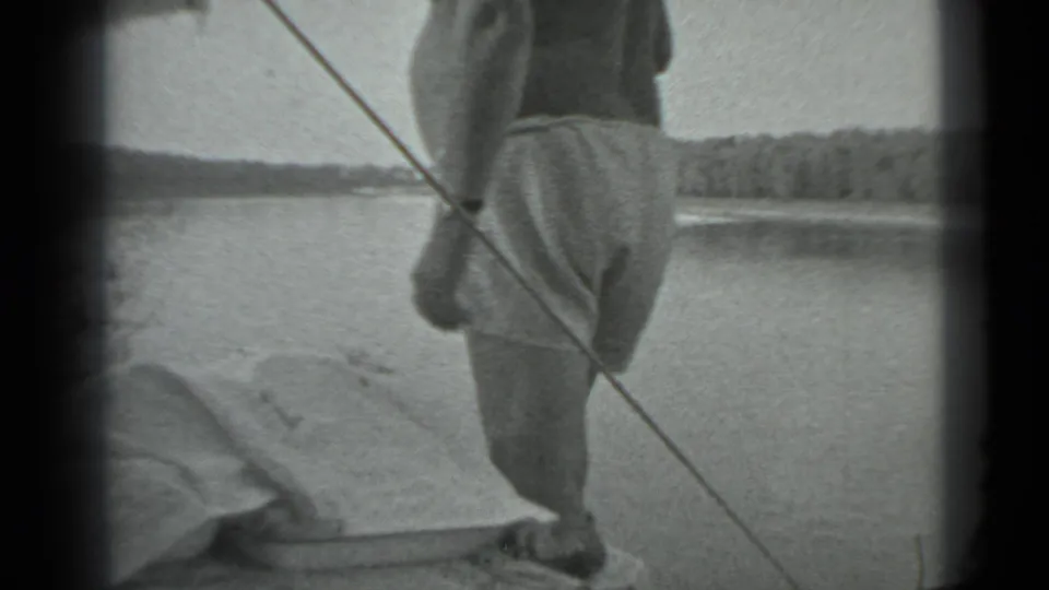 At the end of the 1983 Moscow lakeside clip, the man stands on or near the dock as the fishing line cuts across the frame.