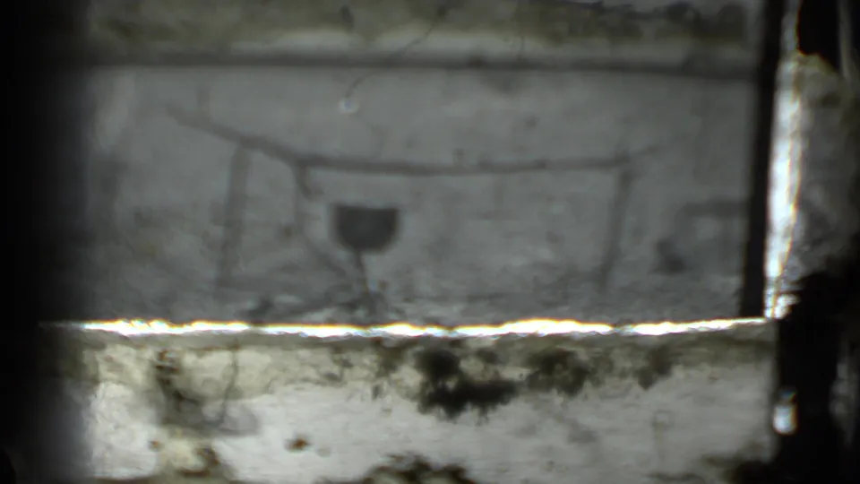 The campfire cooking setup appears again, partly blocked by a bright horizontal film or scan artifact.
