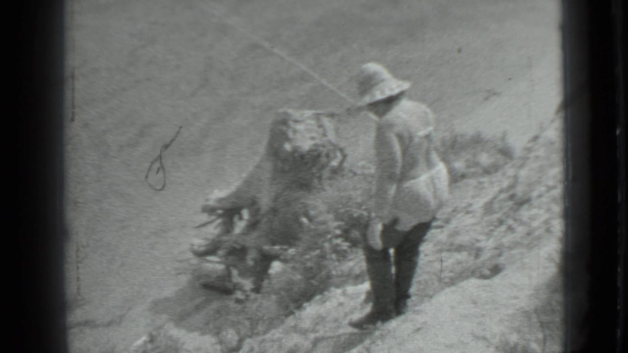 An adult man in a brimmed hat stands on a rocky bank beside the river, with fishing gear visible in the 1983 Moscow clip.
