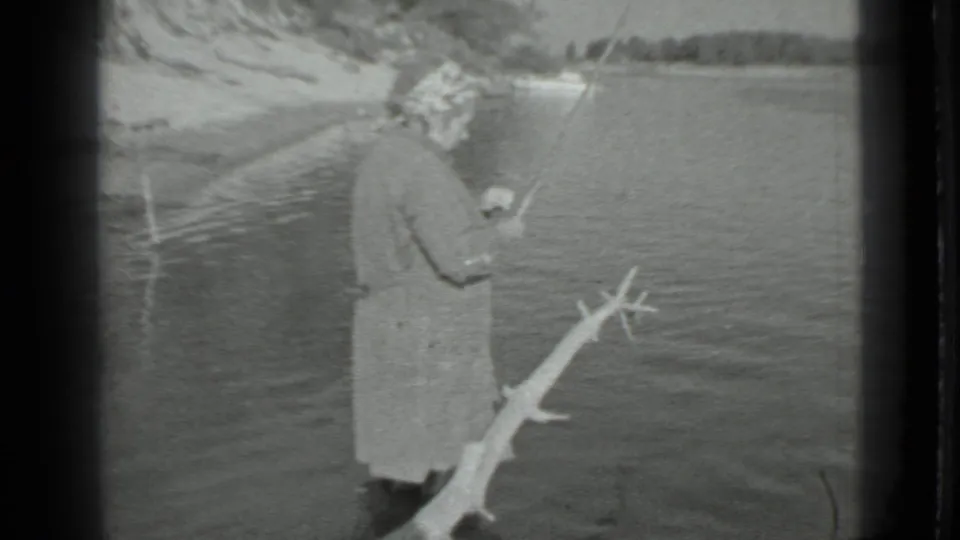 The final frame shows the woman at the lake edge in 1983 Moscow footage, with her fishing rod angled over the water.