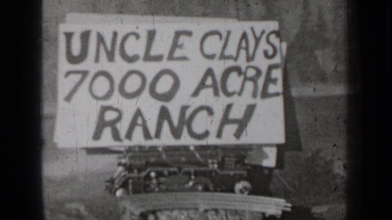 Uncle Clays 7000 Acre Ranch sign fills the frame with dark film edge visible at left.