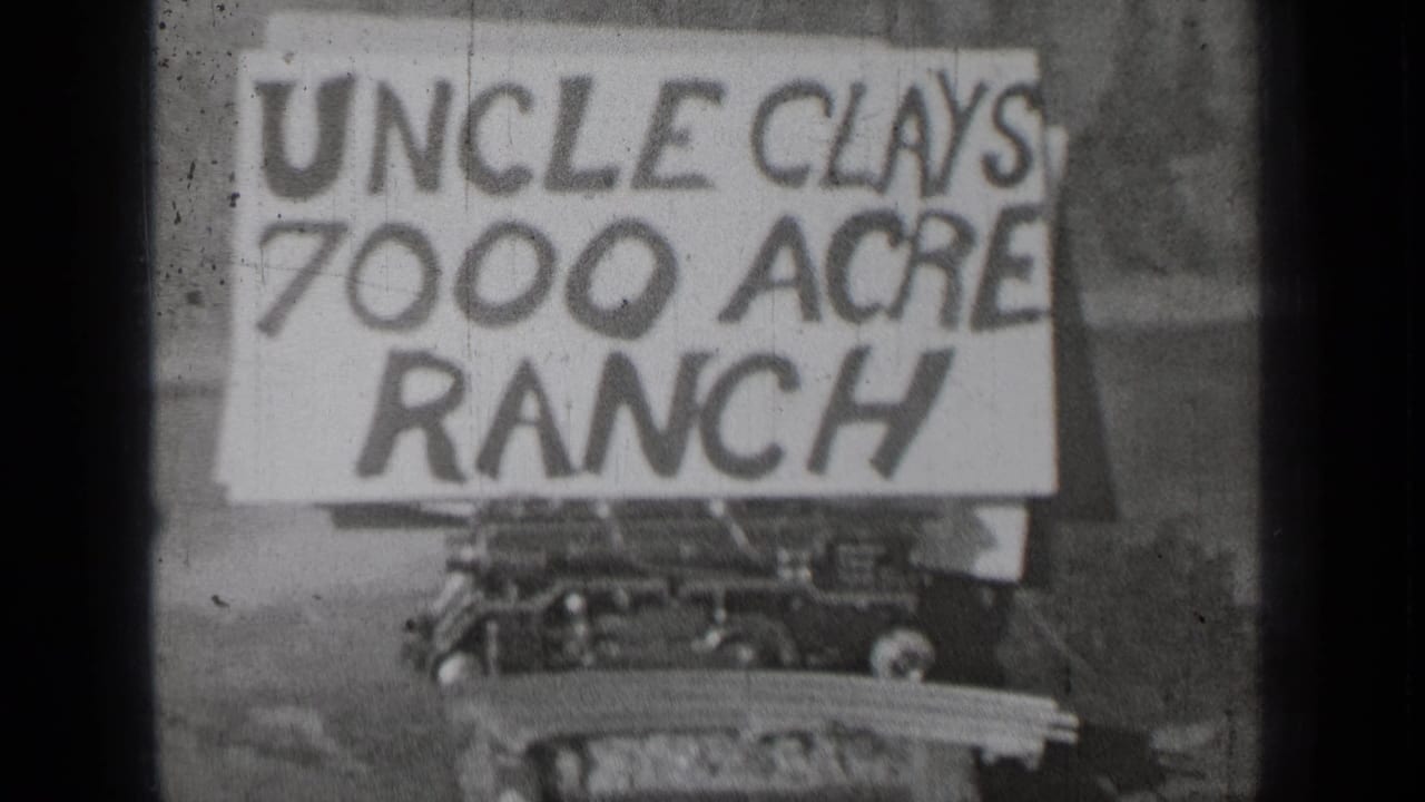 Hand-painted sign reading Uncle Clays 7000 Acre Ranch mounted above a vehicle front.