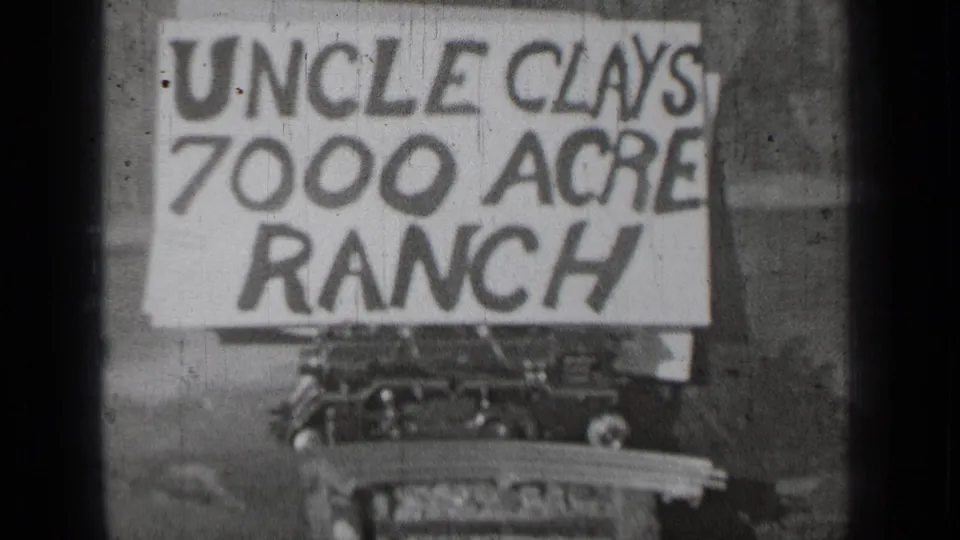 1937 Bend, Oregon 8mm frame showing a hand-painted Uncle Clays 7000 Acre Ranch sign with a car partly visible below.