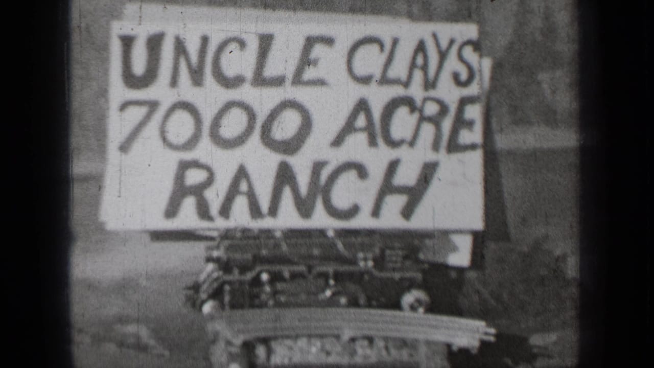 Uncle Clays 7000 Acre Ranch sign centered above a partial car in soft focus.