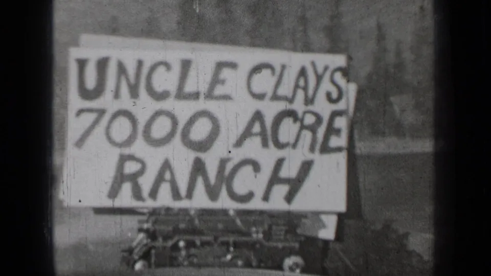 Final 1937 Bend, Oregon frame of the hand-painted Uncle Clays 7000 Acre Ranch sign, with rural background and car detail below.