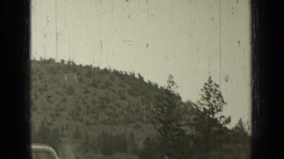 Opening 8mm frame shows a forested hillside near Bend, Oregon, with heavy film borders and soft exposure.