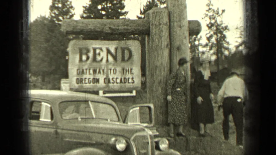 Final frame shows adults near the Bend, Oregon gateway sign, with a 1930s car in the foreground.