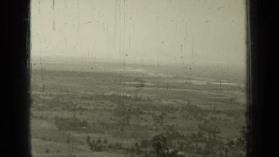 1937 rural Bend-area landscape with fields, scattered trees, faint roads, and visible 8mm film wear.