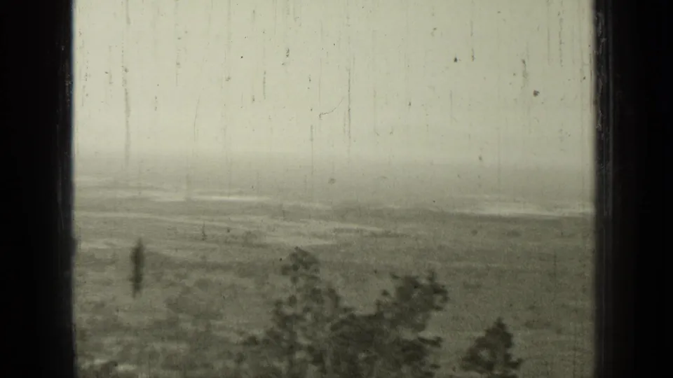 Bend, Oregon rural view from 1937 showing open land, foreground trees, cloudy sky, and worn 8mm texture.