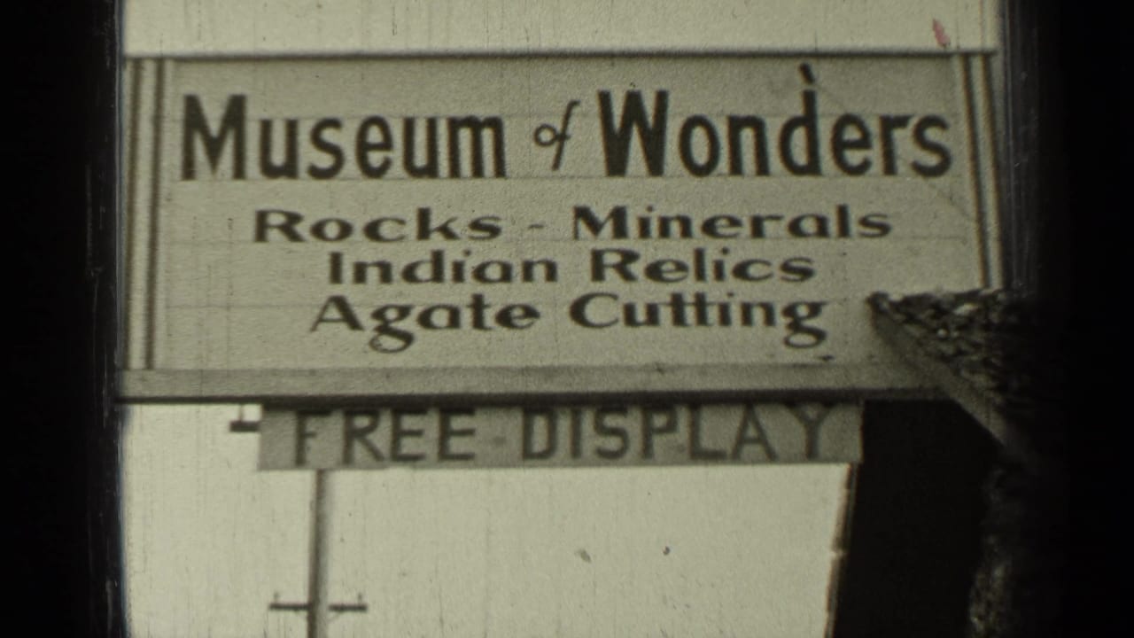 Close view of a Museum of Wonders roadside sign listing rocks, minerals, Indian relics, and agate cutting.