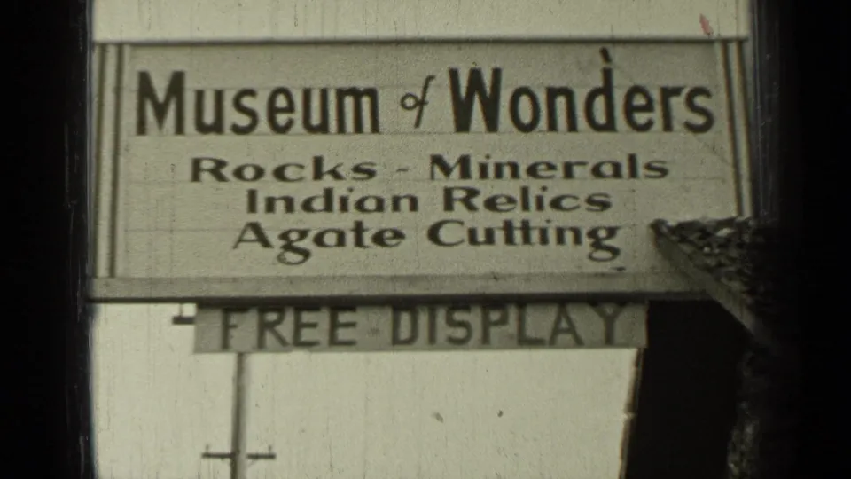 1937 Bend, Oregon 8mm frame showing a close Museum of Wonders sign with Free Display board partly visible below.