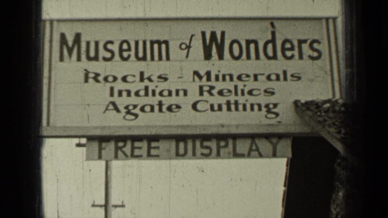 Close view of the Museum of Wonders sign and partial Free Display board on a building exterior.