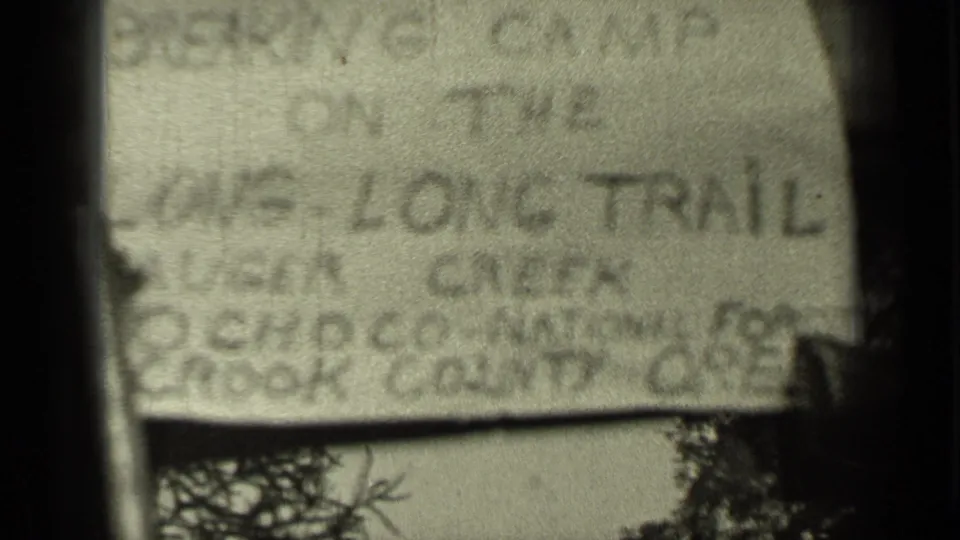 Another soft-focus 8mm view of the handwritten card, with Bend, Oregon and Long Trail wording partly legible.