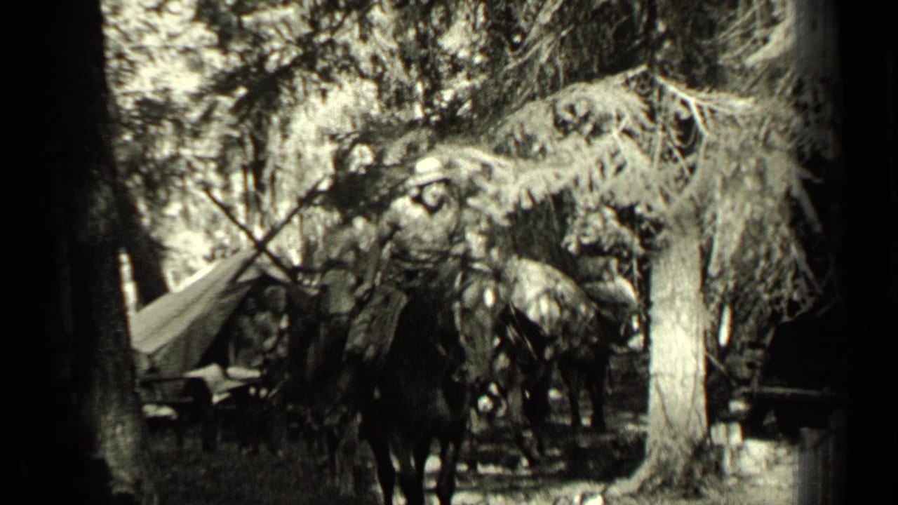 Mounted riders and pack horses move through a wooded camp area with canvas gear visible.