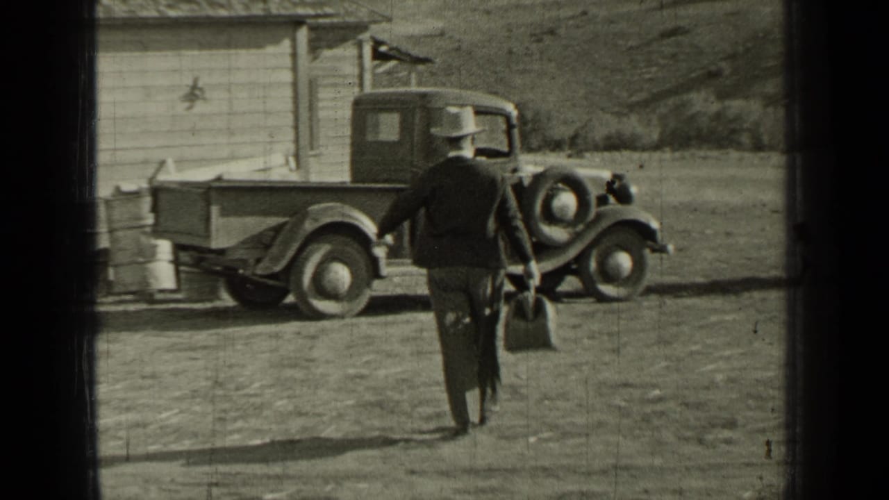 A man in a hat approaches a 1930s pickup parked near a wooden outbuilding in rural Bend, Oregon.