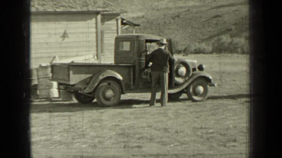 In the final frame, the man stands at the side of the pickup parked beside a wooden outbuilding in Bend, Oregon.