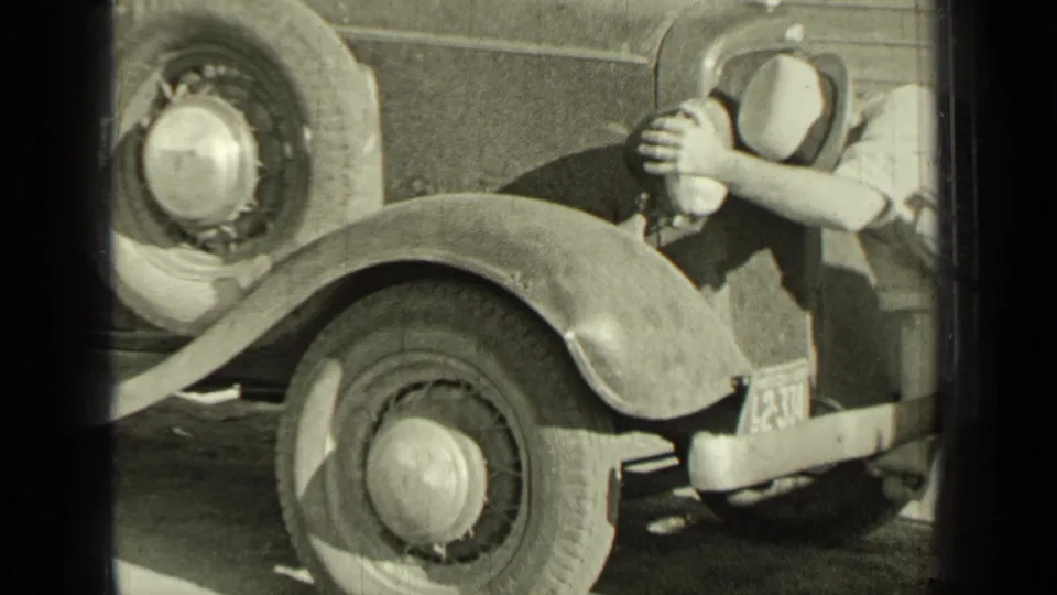 The final frame shows the vehicle's front wheel and fender as a man reaches toward the headlamp or wheel area.
