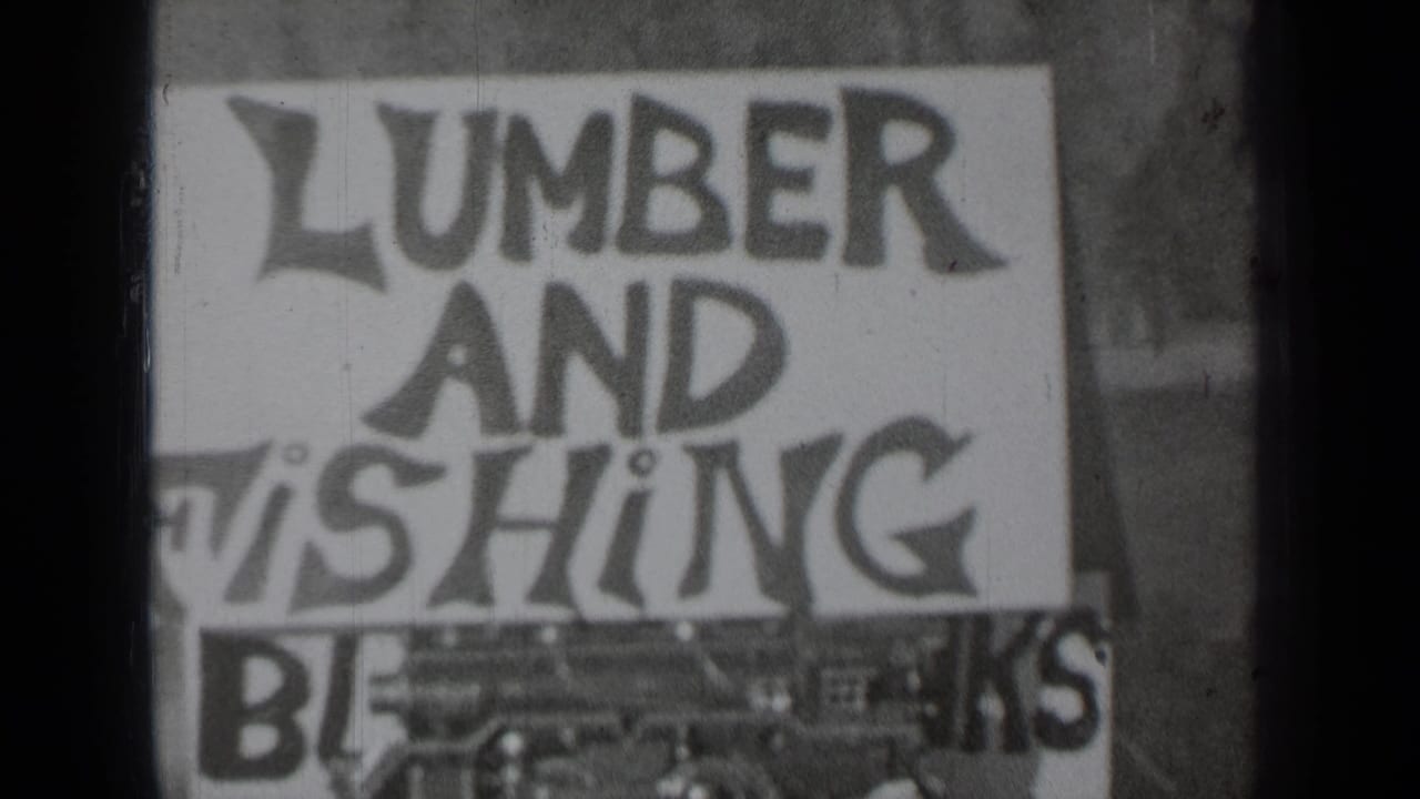 Close view of a hand-painted sign reading lumber and fishing with partial lower lettering.