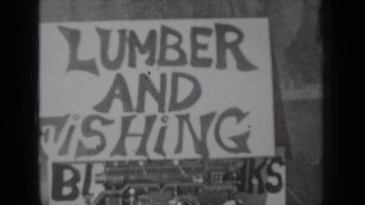 Similar close-up of the lumber and fishing sign with dark film divider at left.