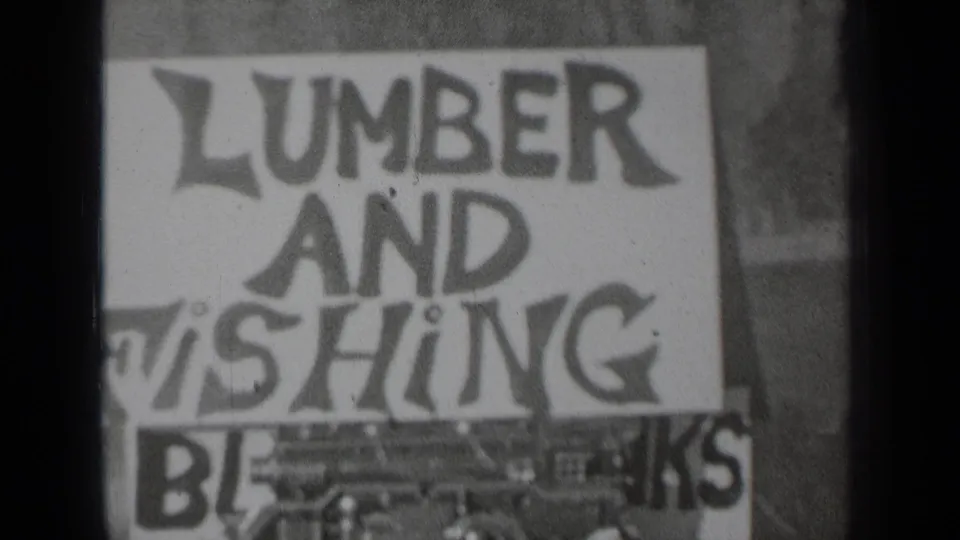 1937 Klamath, California frame with the lumber and fishing sign repeated in the contact sheet, softened by grain and gate shadow.