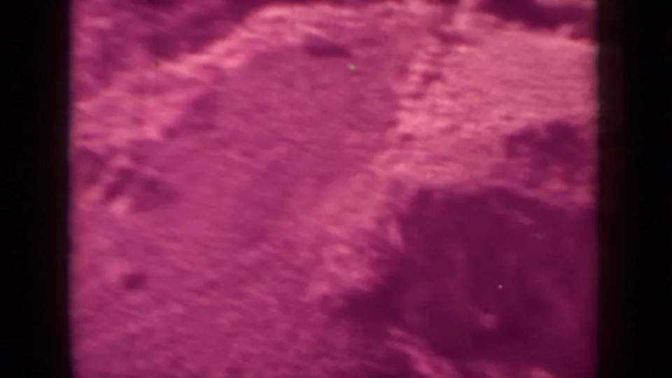 Blurred 8mm view of rugged terrain near Klamath, California, with strong magenta color shift and gate edges.