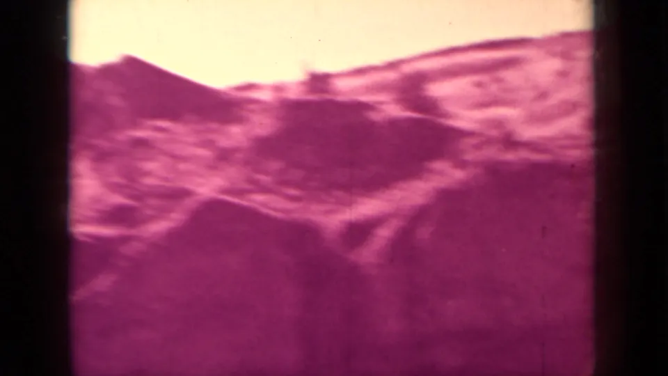 1937 8mm frame with a soft view of mountain slope and roadside terrain in the Klamath area.