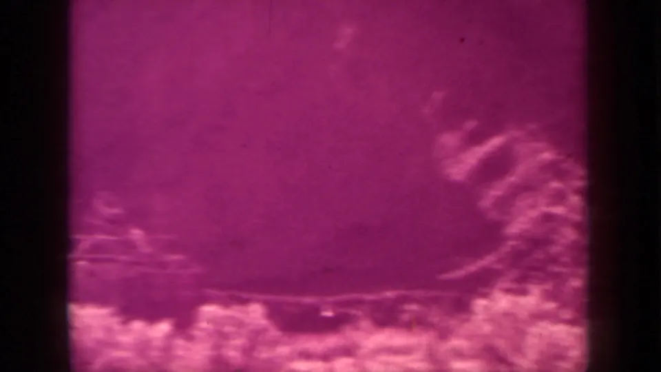 1937 Klamath 8mm frame with pale organic-looking texture along the lower edge and a dark vertical bar through the scan.