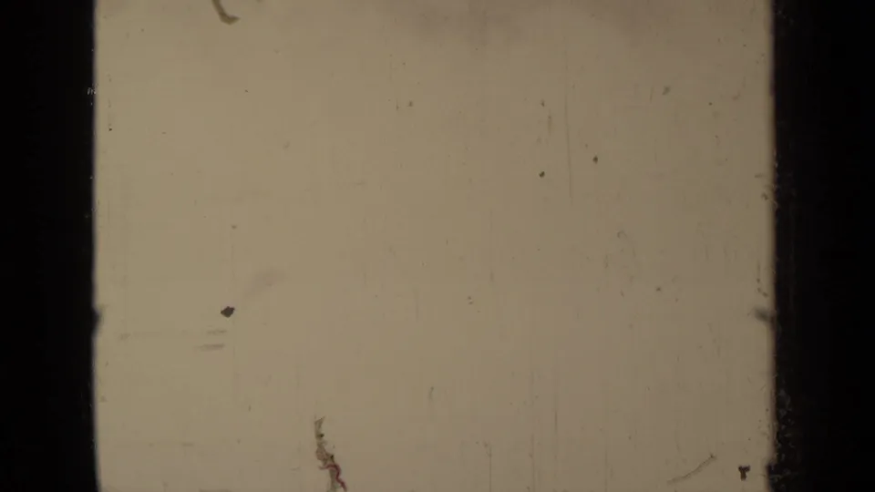 Faded 8mm frame from the Klamath, California clip, with the outdoor scene nearly washed out by exposure and age.