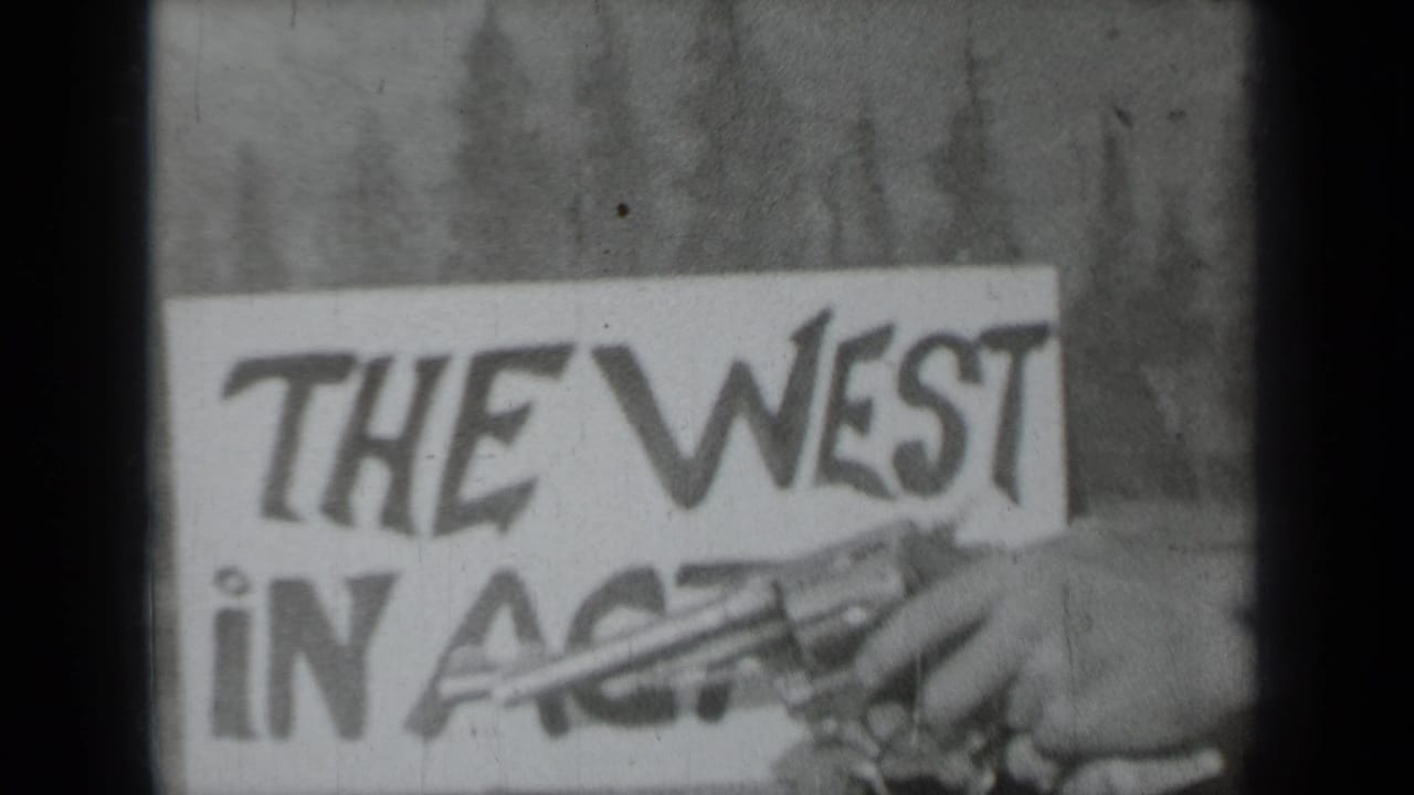 Handmade sign reading The West in Action with toy revolver partly visible.