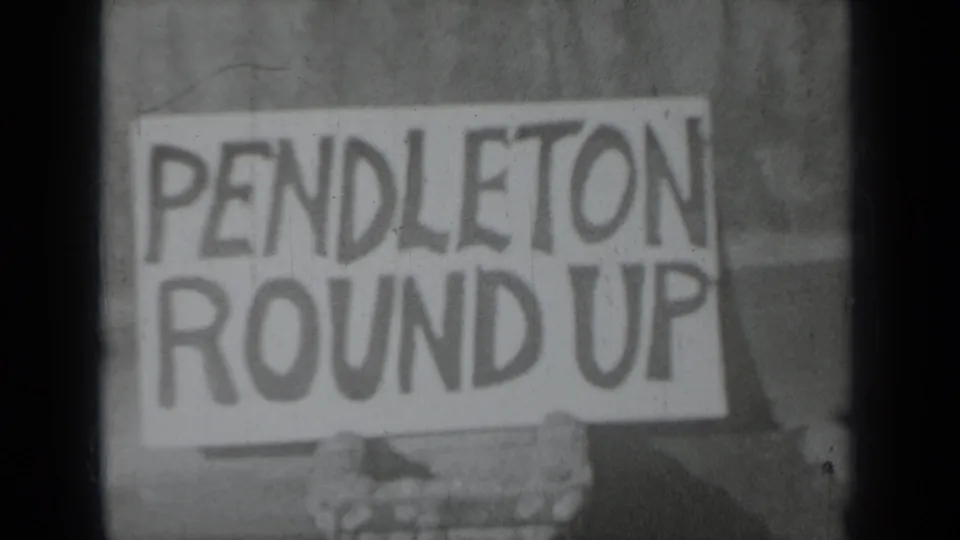 1937 Klamath, California 8mm frame showing a handmade Pendleton Round Up sign held close to the camera.