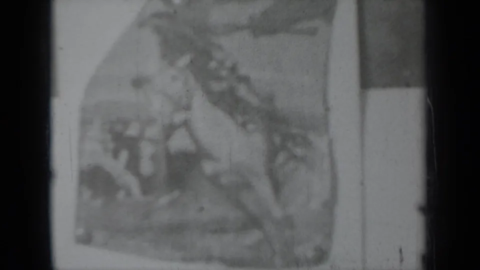 Soft black-and-white 8mm view of a printed rodeo illustration panel, likely connected to the Pendleton Round Up display.