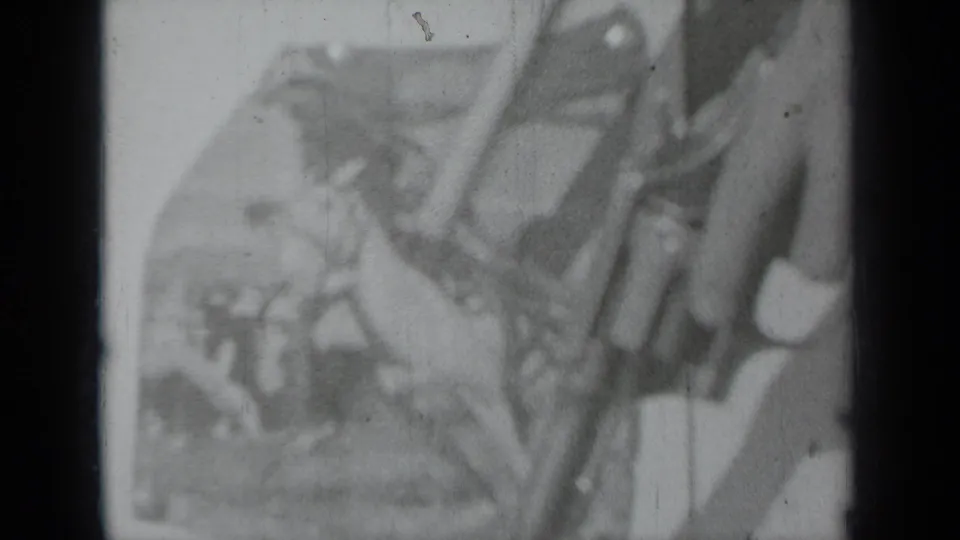 Grainy 8mm frame with a handled long gun crossing a rodeo-themed poster in a 1930s Klamath setting.