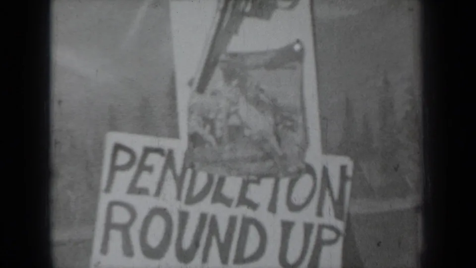 Frame showing a Pendleton Round Up sign with revolver details above it in 1937 archival home-movie footage.