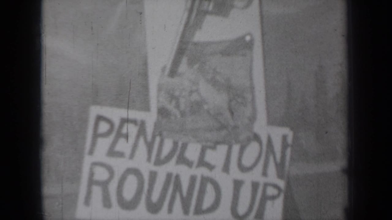 Hand-lettered paper sign reading Pendleton Round Up with a drawn revolver above it.