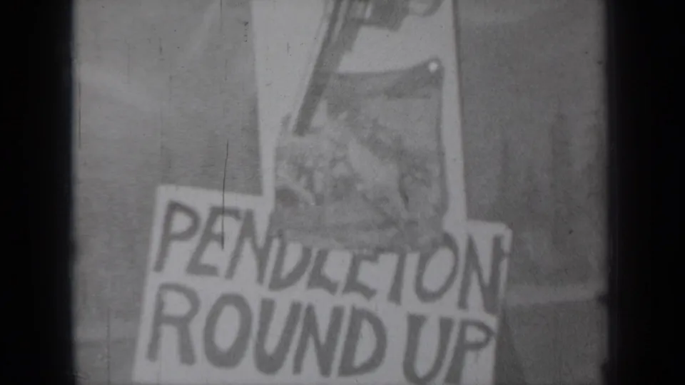 1937 Klamath, California 8mm frame showing a handmade Pendleton Round Up paper sign with bold lettering and a revolver illustration.