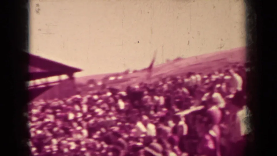 1937 Klamath, California home-movie frame showing a dense outdoor crowd across a sloped public gathering area.