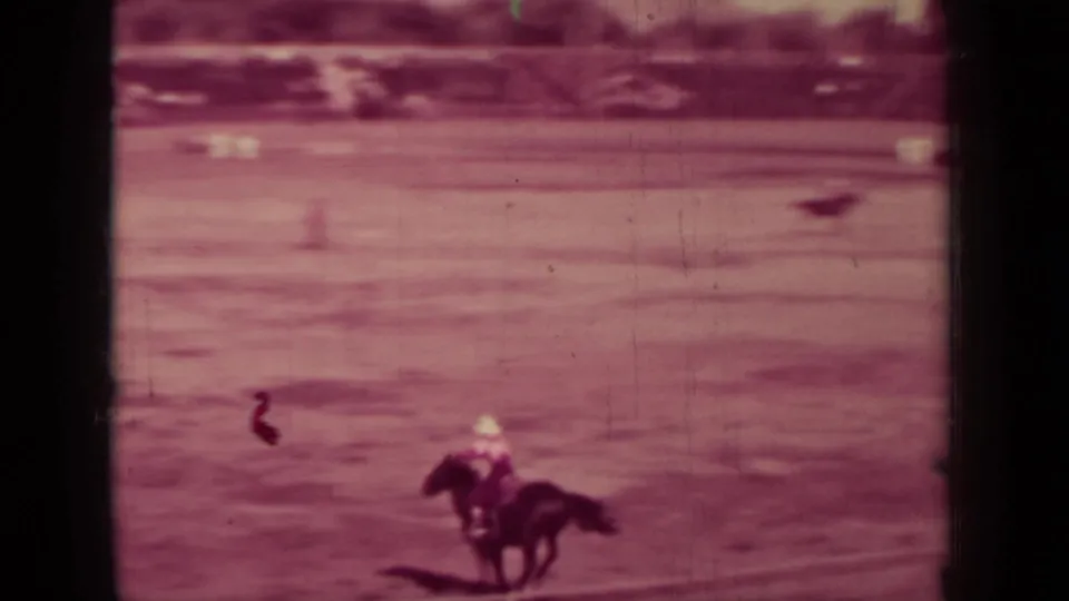 A rider on horseback moves through an outdoor arena in 1937 Klamath, California, seen in faded 8mm home-movie footage.