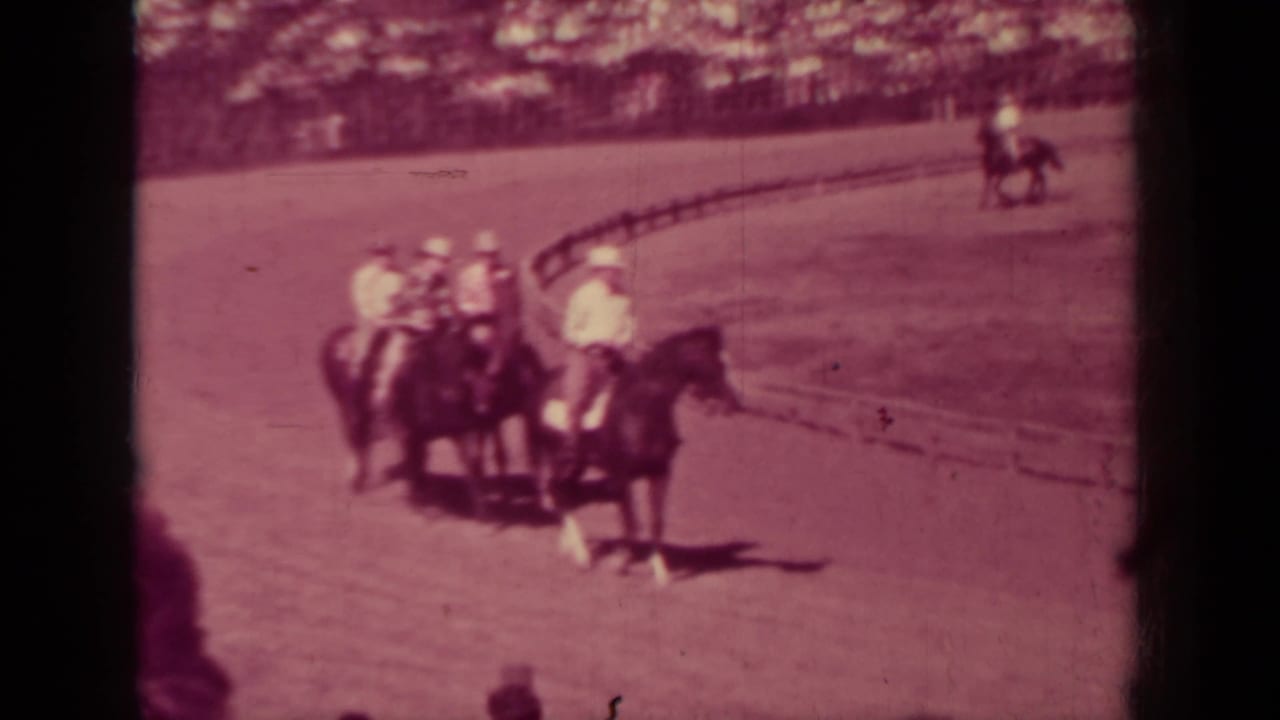 Mounted riders in light shirts and hats cluster near the arena rail during a 1937 Klamath, California equestrian event.