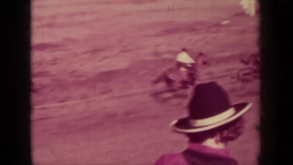 1937 Klamath, California racing view with a jockey on horseback and spectators in hats looking toward the dirt course.