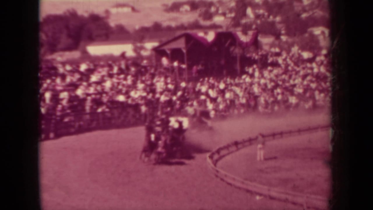 A horse-drawn carriage travels along the fairground track in front of dense spectators, consistent with the supplied Klamath 1937 metadata.