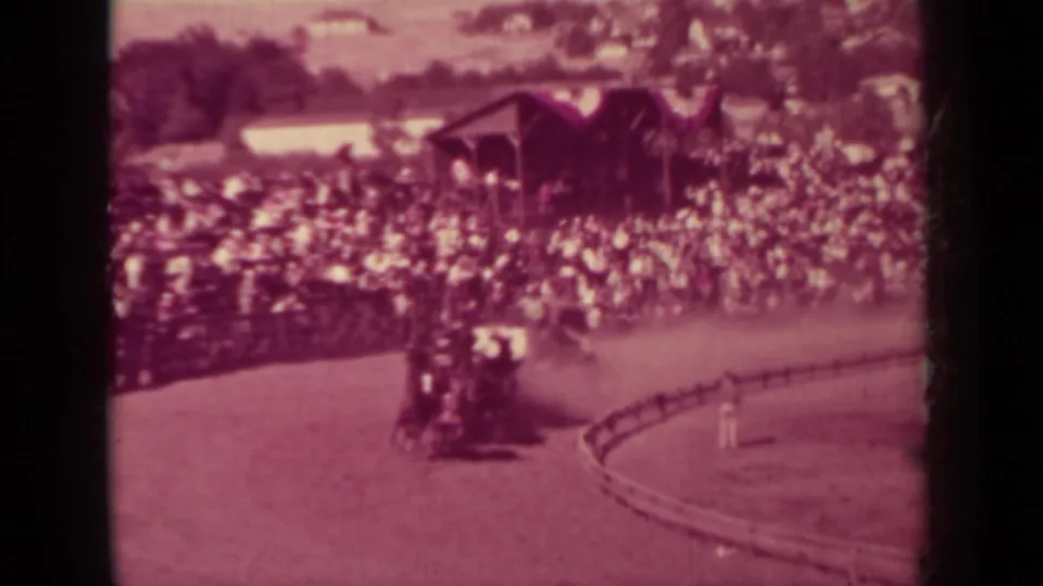 A horse-drawn carriage travels along the fairground track in front of dense spectators, consistent with the supplied Klamath 1937 metadata.